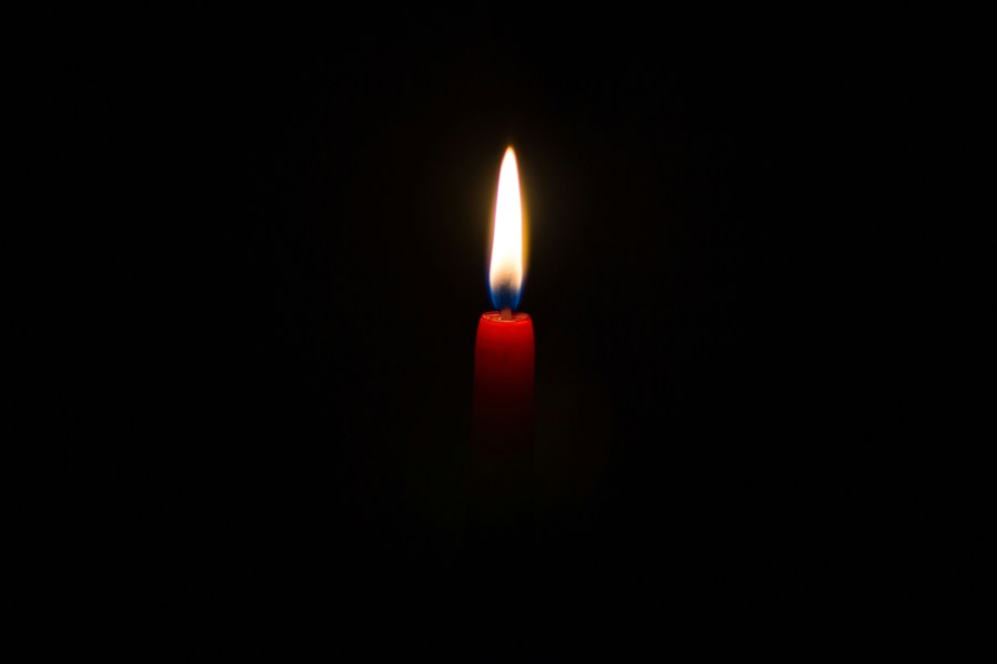 A single candle surrounded by darkness